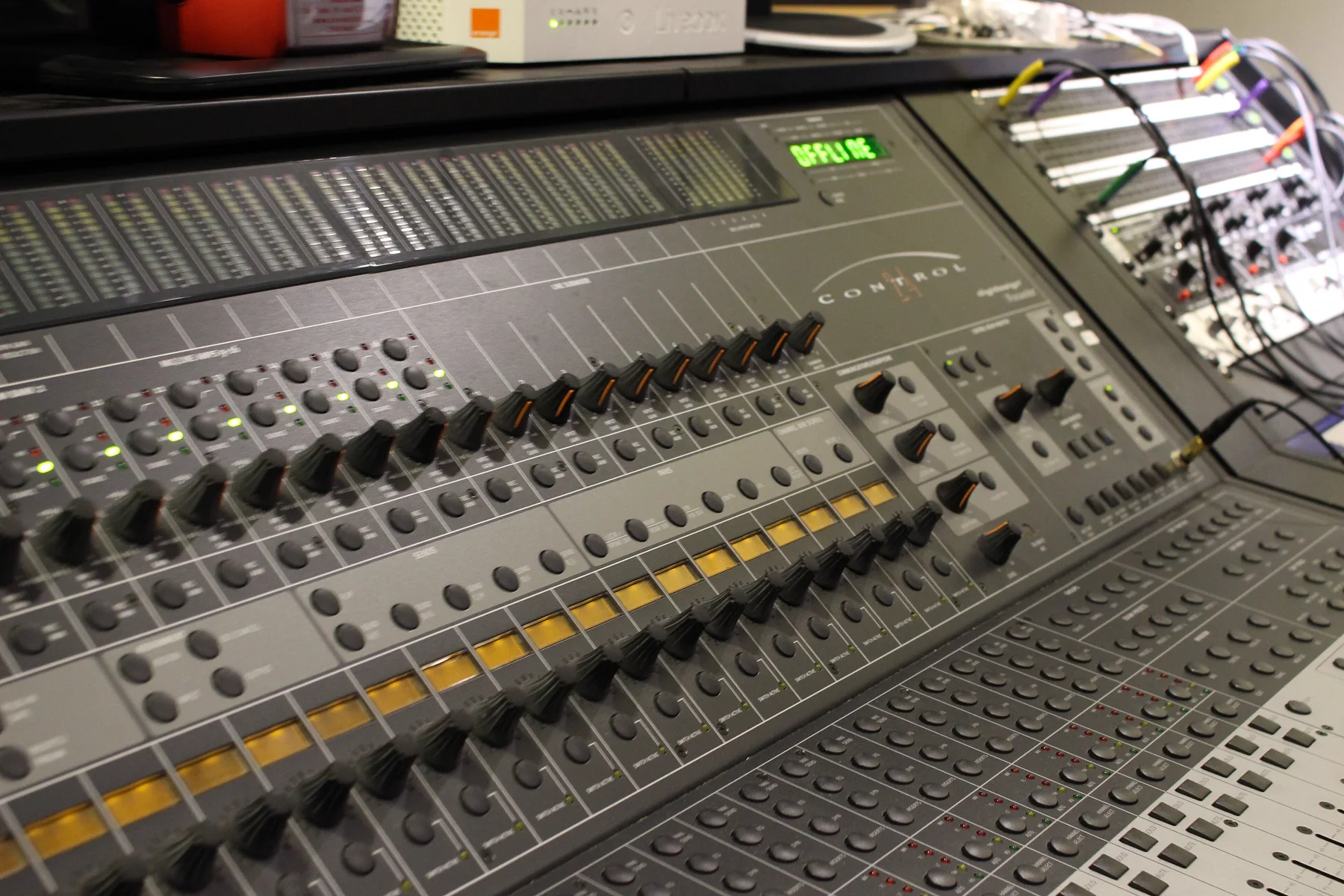 A Control 24 showing OFFLINE on its display, amber scribble strips and encoder rows